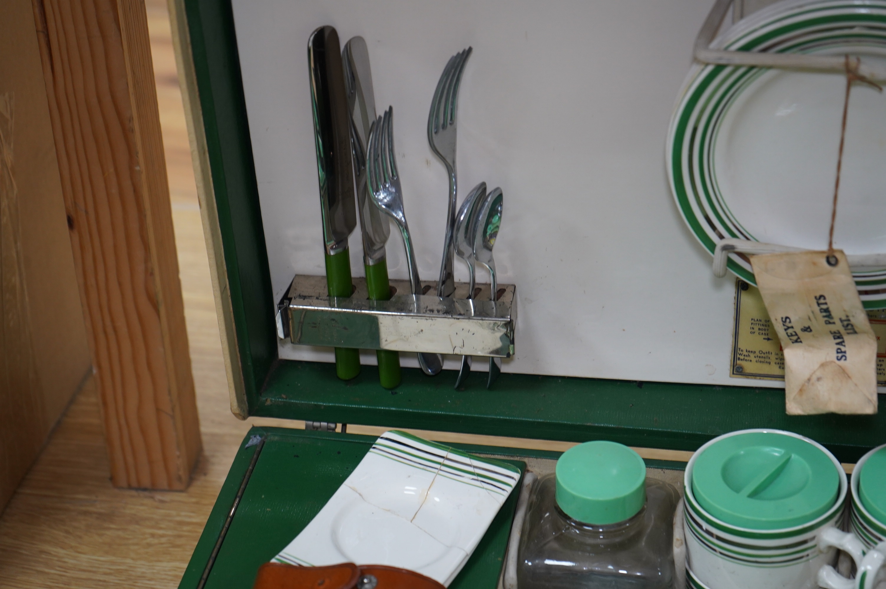 An Art Deco, c.1930's cased picnic set with flasks, cutlery, plates and cups. Condition - poor